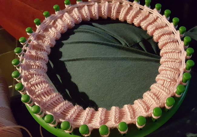 Knitting a beanie on a loom