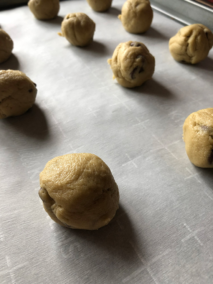 Protein Powder Cookie Dough Balls On Cookie Sheet