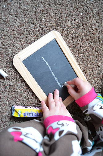 Child drawing with chalk